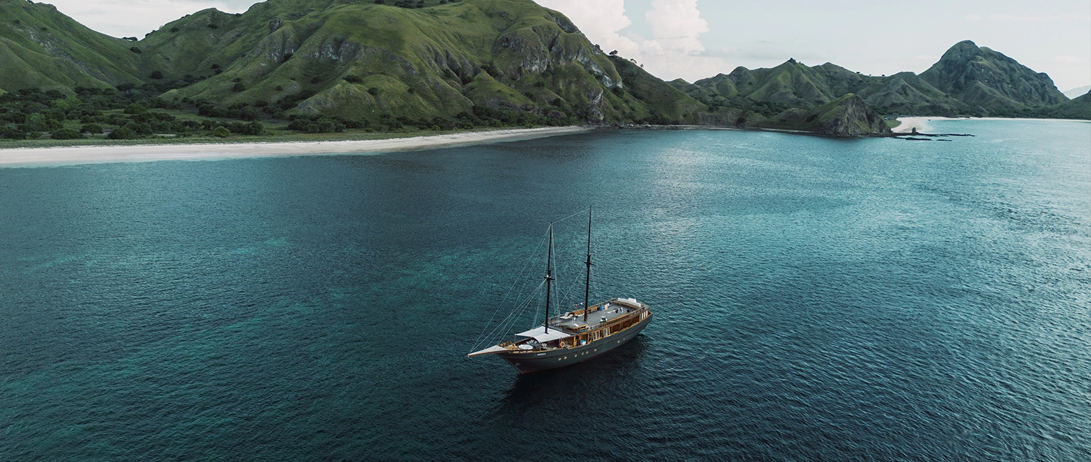 Clear blue skies and anchored boat in Komodo during dry season
